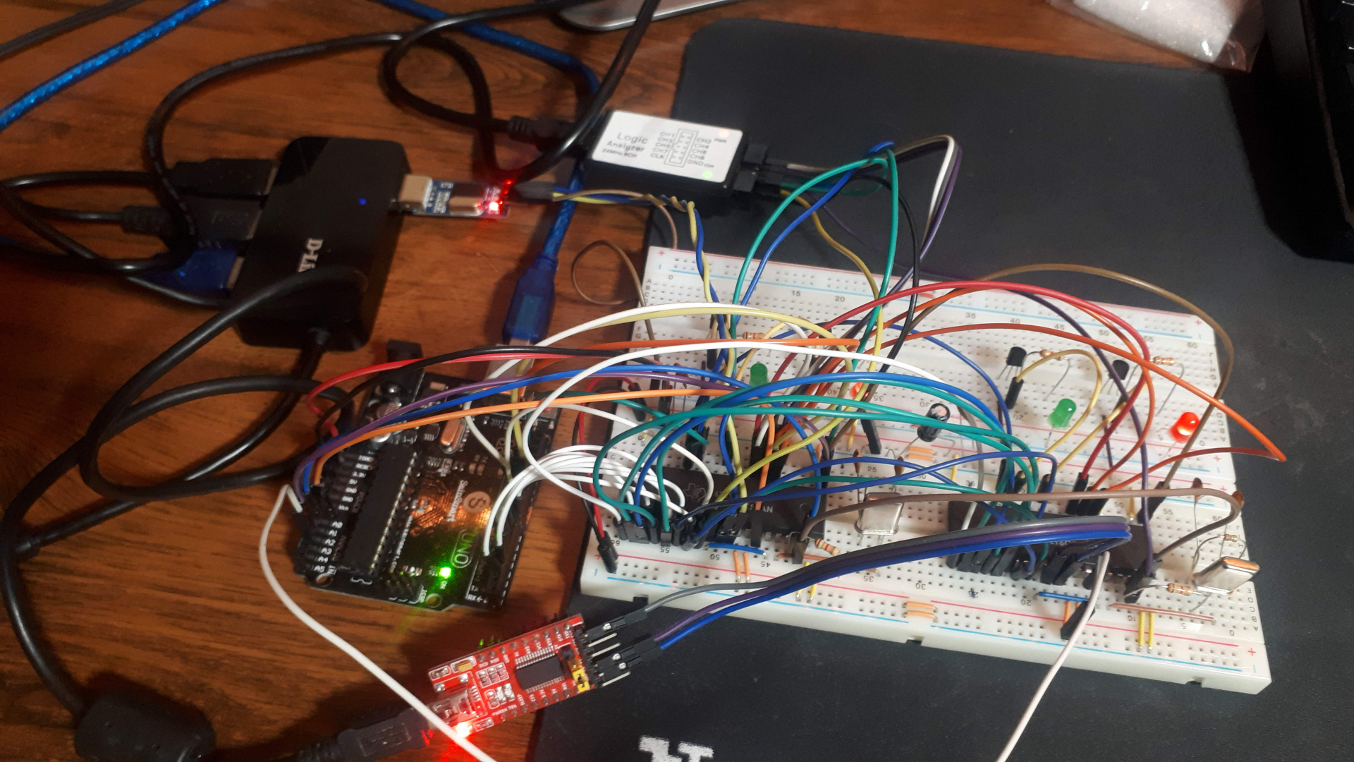 Breadboard with a real mess of wires connecting 2 ACE(UARTs) to an Arduino Uno, logic analyzer and 2 serial to USB converters