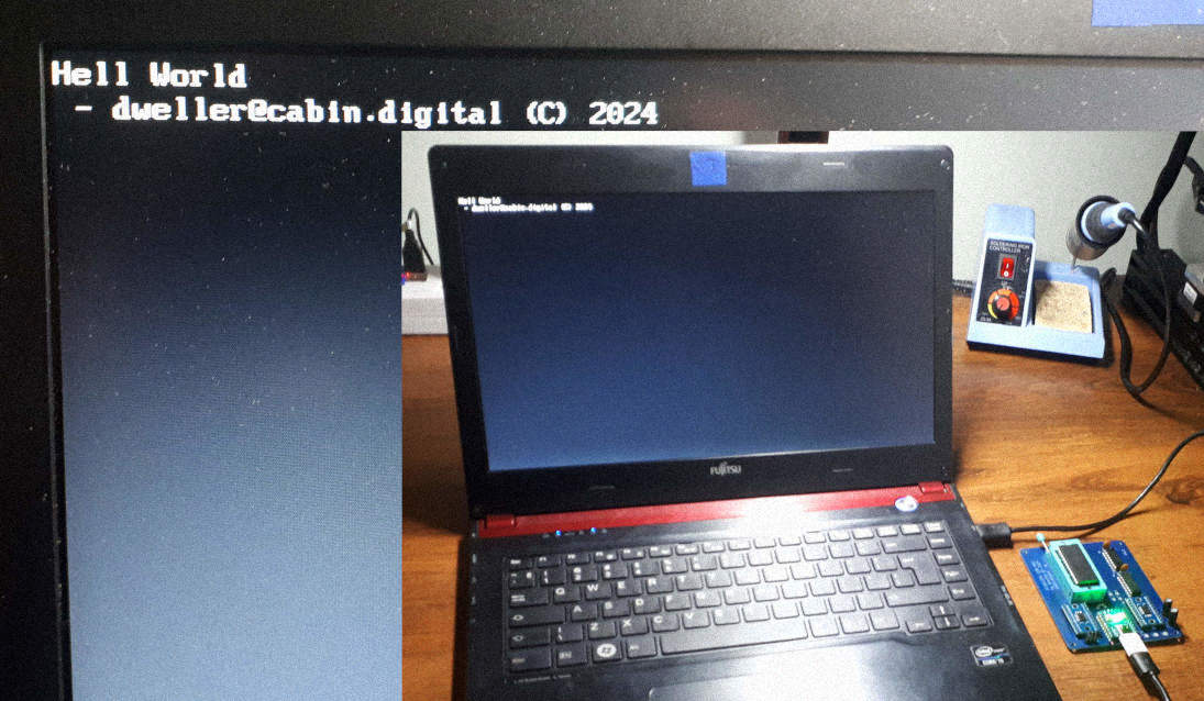 Photo of a laptop saying “hell world” with the EEPROM USB device connected to it